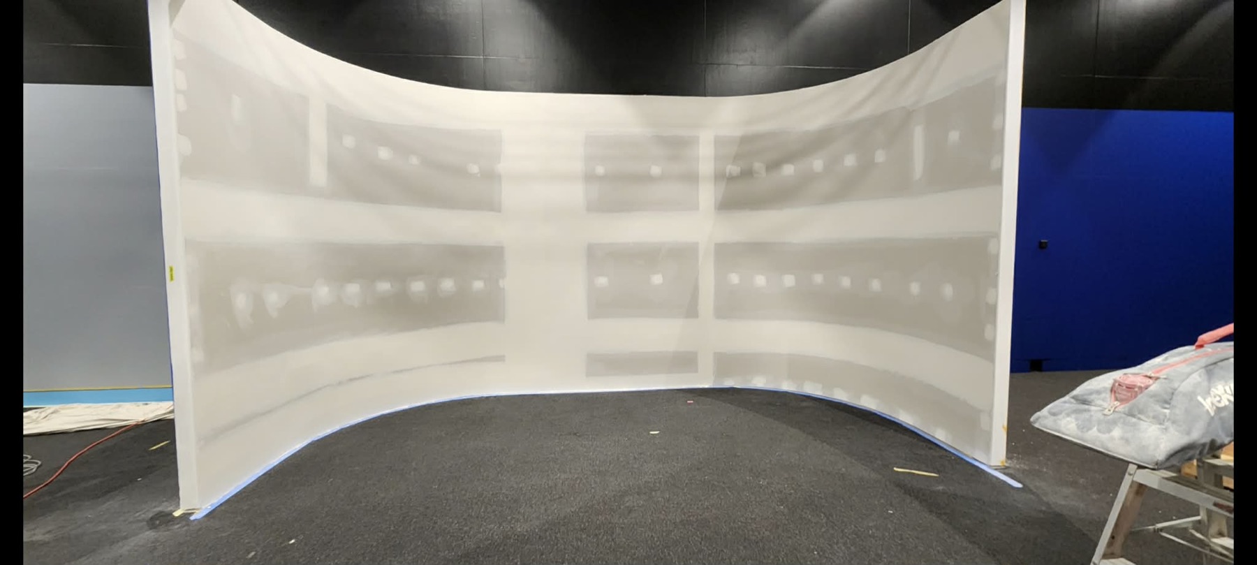Curved plaster feature wall in progress with smooth radius stopping.